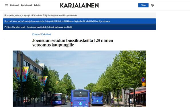 Kuvassa sanomalehti Karjalaisen verkkolehti otsikoineen kuvakaappauksena. Valokuvassa katu, jossa näkyy sinisiä busseja takaapäin.